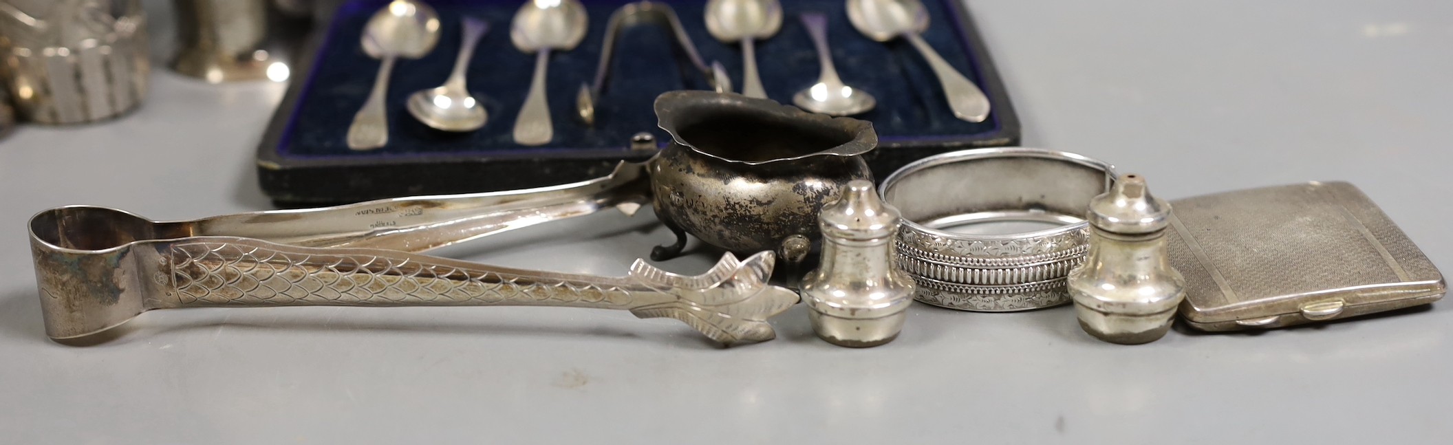 A Siamese sterling two handled ice pail with tongs, height 12.5cm, together with a cased set of six teaspoons with tongs, a silver compact a silver Vogel travelling timepiece on albert chain, three silver condiments, two